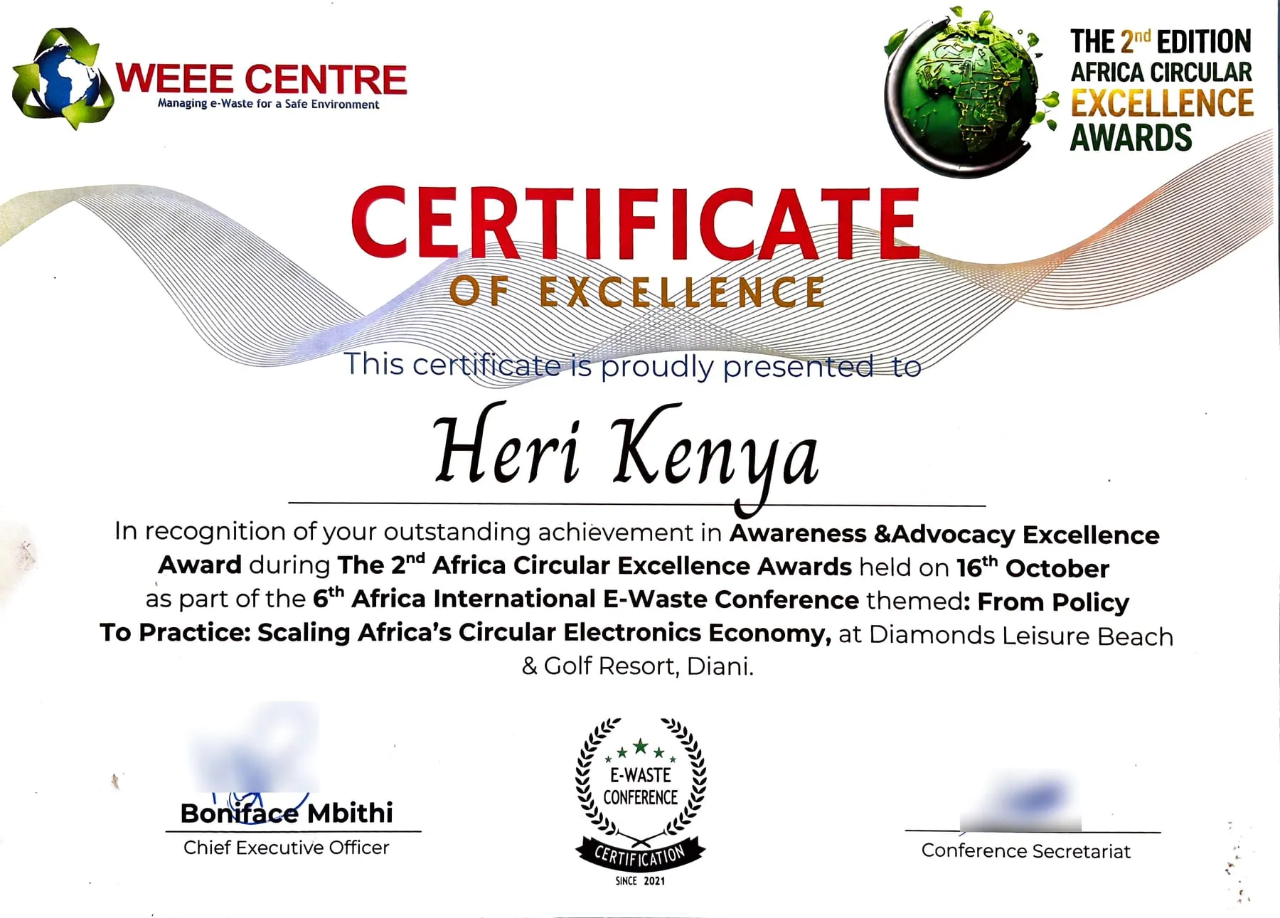 Certificate of Excellence from WEEE Centre presented to HERI-Kenya
