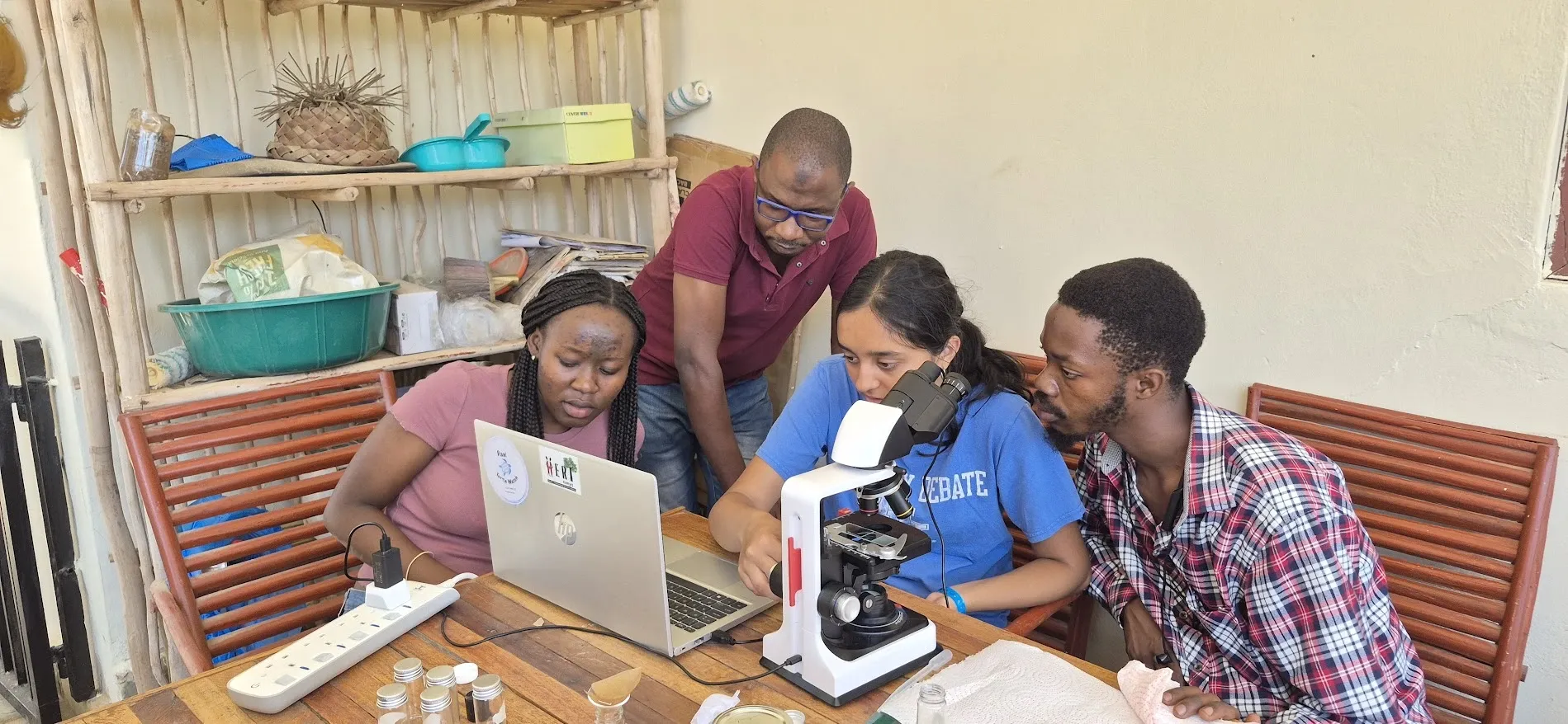 Students and young researchers learn to use a microscope with HERI-Kenya